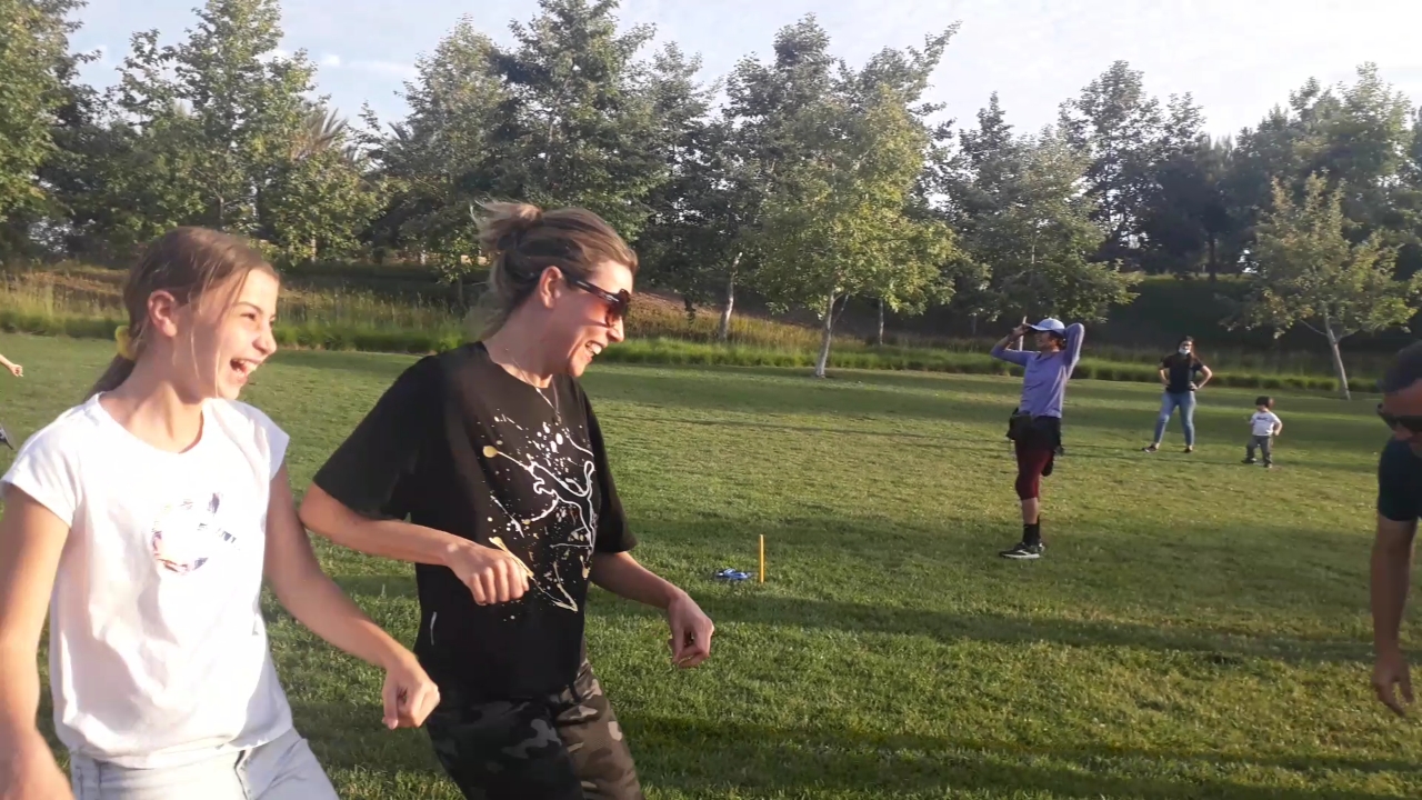 Coach Victory training with athletes outdoors